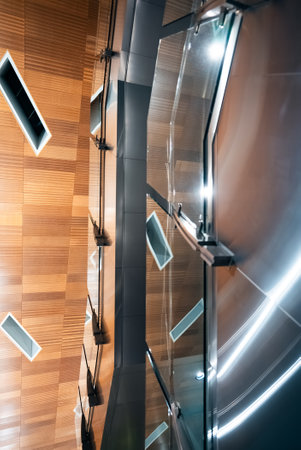 Sleek Modern Building Interior with Glass Railings and Wood Panels, Elegant Contemporary Office Lobby Featuring Glass Barriers and Wooden Accentsの写真素材