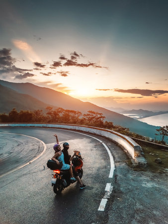 happy romantic couple in love on motorcycle in mountains, adventure and joyful freedom, lovely pair riding bike in rugged peaks, passionate journey and scenic excitementの写真素材