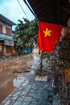 flooded city or town with buildings submerged in overflow water and mud, village underwater after heavy tropical rain and typhoon, consequences with dirt on the streetの写真素材
