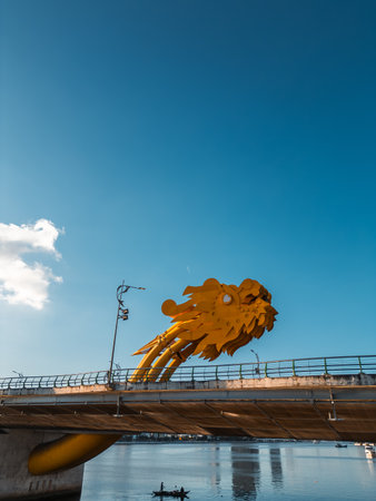 Golden Dragon Bridge over Han River in Da Nang at sunset, Iconic Vietnamese landmark spanning urban waterway with city skyline viewの写真素材