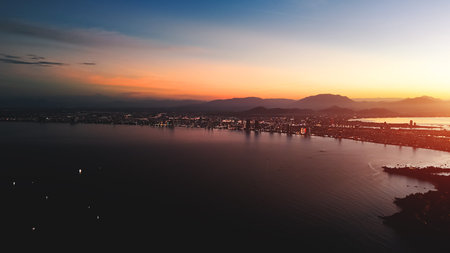 Danang aerial sunset over city sea and mountains skyline, Evening panorama Da Nang coast city lights...