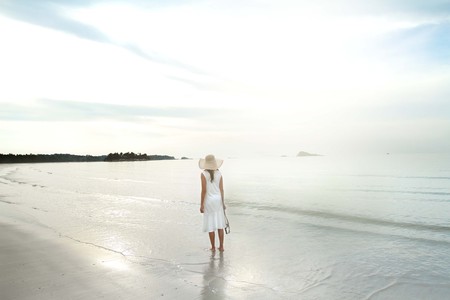 Woman on the beach by herselfの写真素材