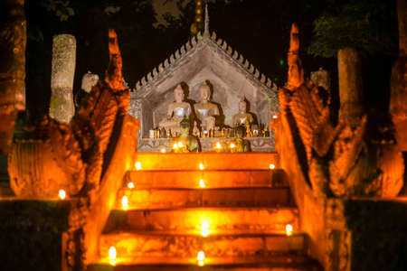buddha thai art with oil lamp in temple at nightのeditorial素材