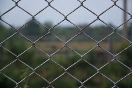 Chain link fence with blur backgroundの写真素材