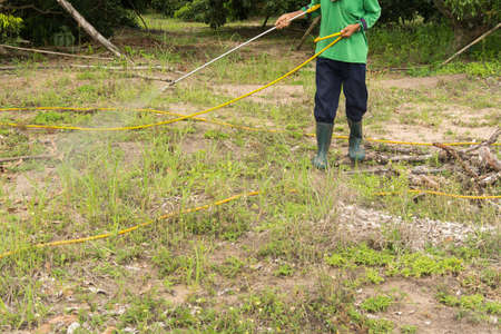 A man is spraying herbicide in framの写真素材