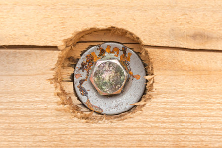 Rusty bolt on wooden background