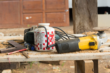 Yallow  grinder and wooden table in  workshopの写真素材