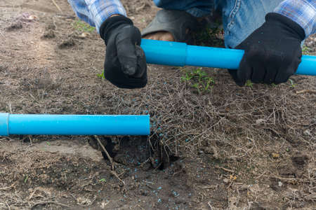 Plumber connect a pvc pipe at fieldの写真素材