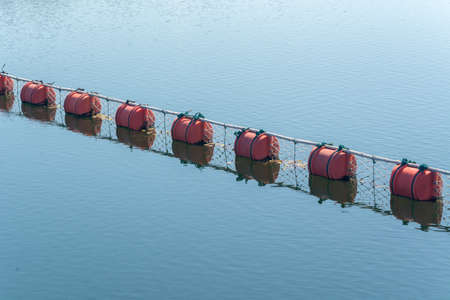 Red buoy  floating on waterの写真素材