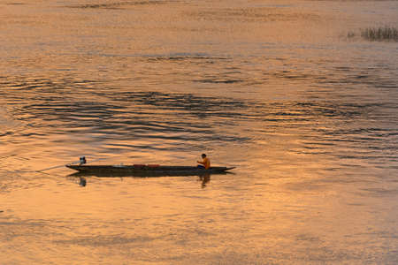Fisherman has a boat on Mekong riverの写真素材