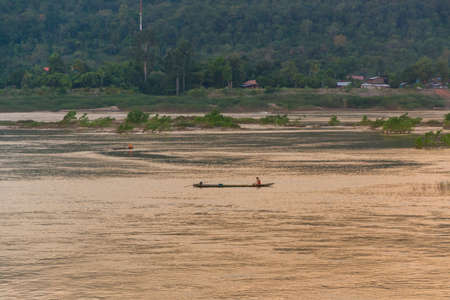 Fisherman has a boat on Mekong riverの写真素材