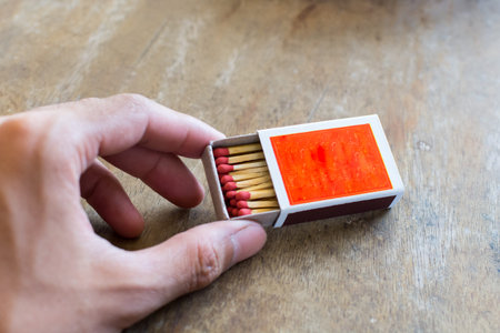 Matches in box with wooden background