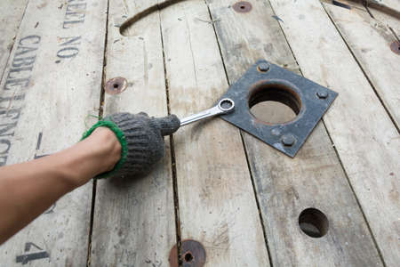 Worker using wrench turns a nutの写真素材