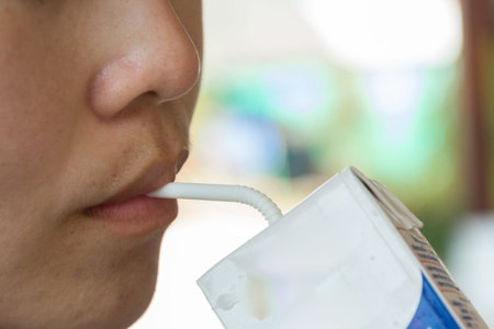 Woman eating milk carton boxの写真素材