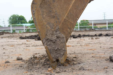 Loader excavator machine doing earthmoving work at construction siteの写真素材