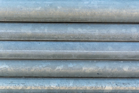 Stacks of steel pipe in factoryの写真素材