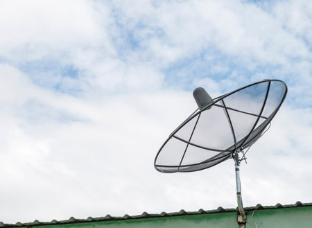 Satrllite dish on the roof and sky background