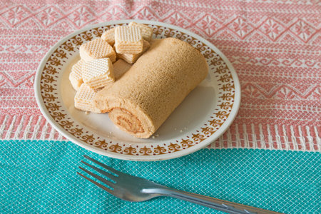 coffee cake roll with wafers on vintage dishの写真素材