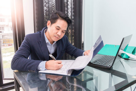 Asian business man working at the office on laptop,Young businesspeople are working in office,bright...