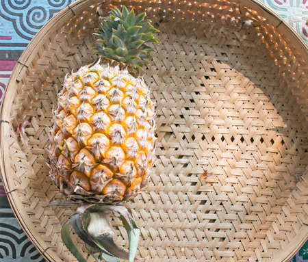 pineapple in basketの写真素材