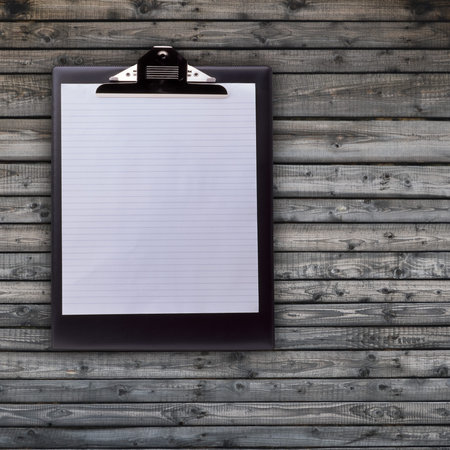 Notepad with blank paper on wooden backgrond