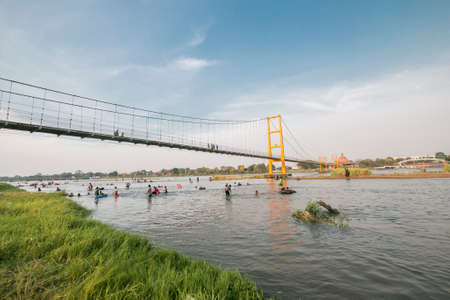 The old wooden bridge across the ping river at Tak Province,Thailandの写真素材