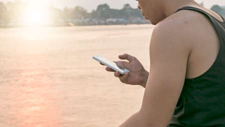 Man use his mobile phone outdoor,close upの写真素材