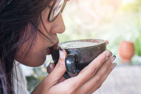 woman drinking coffee latte art,close upの写真素材