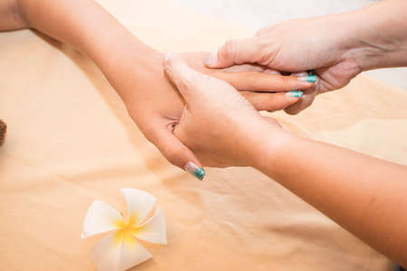 woman relaxing with hand massage at beauty spa. Close-upの写真素材