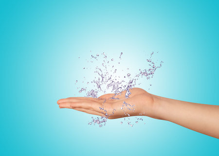woman hand with water splash on white backgroundの写真素材