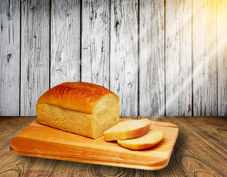 fresh slice bread on chopping wood and wooden background