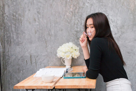 Teenage asian girl with eyeglass relaxing in cafe,life style concept