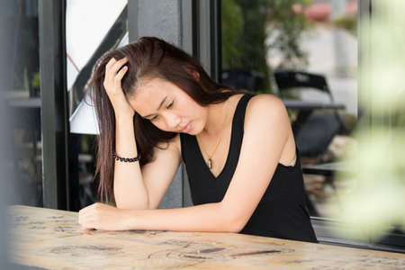 Lonely Asian women sitting at cafe,sad emotionの写真素材