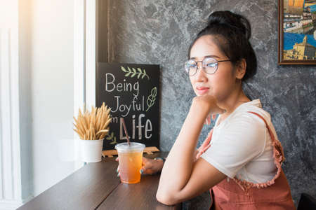 Portrait of a beautiful young asian woman relaxing and thinking at cafe,Life style conceptの写真素材