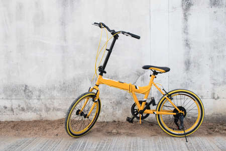 Yellow bicycle on wall backgroundの写真素材
