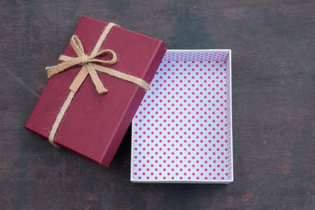 Open vintage red gift box on wooden backgroundの写真素材