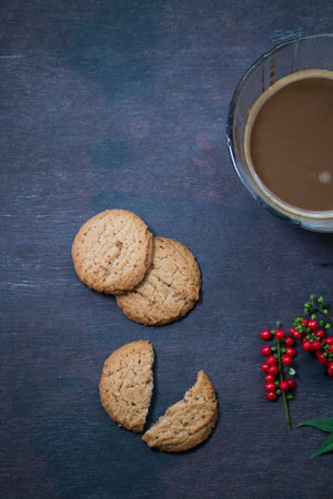 Cookies with coffee cup on dark wooden background,Top viewの写真素材