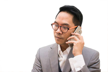 Young asian business man talking telephone on white backgroundの写真素材