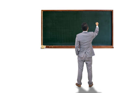 businessman or teacher with marker writing or drawing something on chalk boardの写真素材