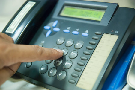 Closeup of male hand holding telephone receiver