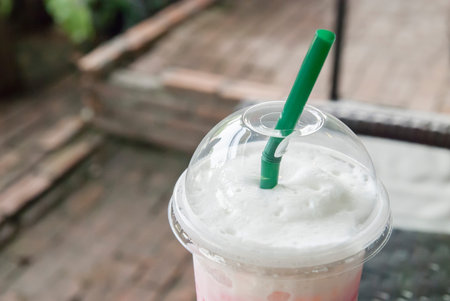 cold milk in plastic glass in cafe