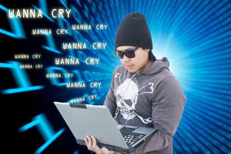 Guy with laptop on white wall,hacker,wanna cry virus