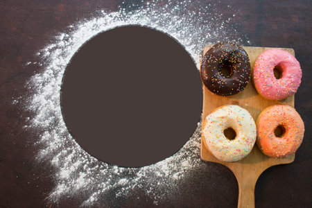 four glazed donut on cutting board with white power circle for you text