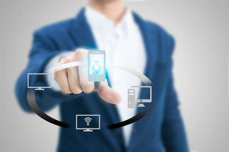 Business person pushing symbols on a touch screen interface,Technology conceptの写真素材