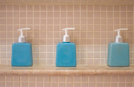 liquid soap and shampoo bottle on the shelf in the bathroomの写真素材