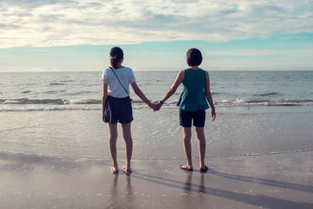 horizon sky background forward looking coupleの写真素材
