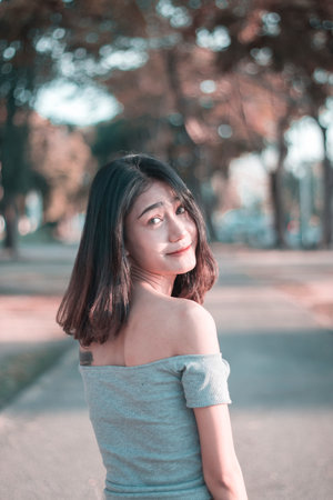 Asisn young woman enjoying her time outside in park