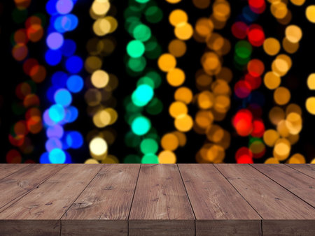 Christmas holiday background with empty wooden table top over festive bokeh light decorat