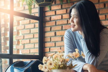 portrait asian girl posing in cafe , smiling girl relax in coffee shop , life style conceptの写真素材