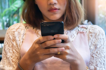 Woman hold with smart phone at coffee shop